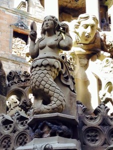 Beautiful mermaid, creepy face behind her in Linlithgow Palace, Scotland